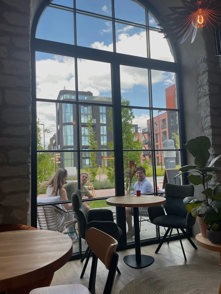 Large arched window inside INTI Café in Volta, Tallinn